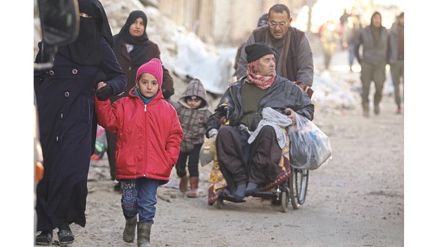 People gather to be evacuated from a rebel-held sector of eastern Aleppo, Syria.