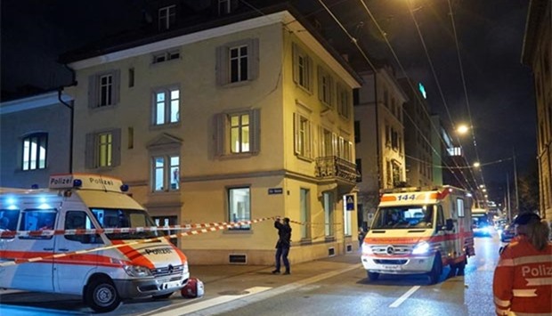 Ambulance and police cars are seen outside a Muslim prayer hall in central Zurich, after three people were injured by gunfire on Monday.