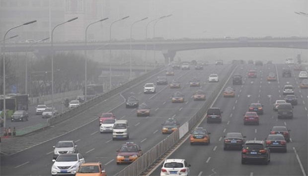 Smog hangs over a road on a polluted day in Beijing on Tuesday.