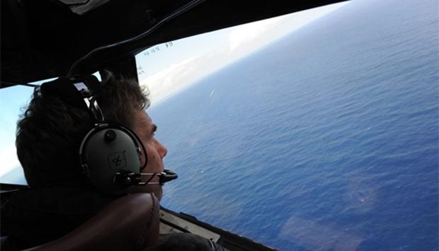 A Royal New Zealand Airforce co-pilot is helping to look for objects during the search for Malaysia Airlines flight MH370, off Perth in Western Australia, in this file photo taken on April 13, 2014.
