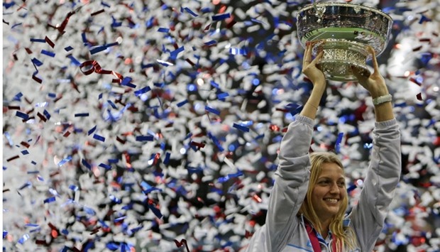 Petra Kvitova celebrates with the trophy after winning their final match of the Fed Cup tennis tournament against Russia in Prague, Czech Republic, November 15, 2015