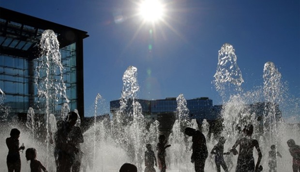People cool off in fountains