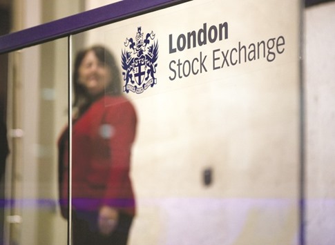 A visitor passes a sign inside the London Stock Exchange. The FTSE 100 closed up 0.4% to 7,043.96 points yesterday.