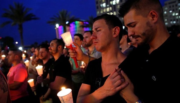 People gather for a candlelight vigil during a memorial service for the victims of the shooting at the Pulse gay nightclub in Orlando, Florida, June 13, 2016. Reuters