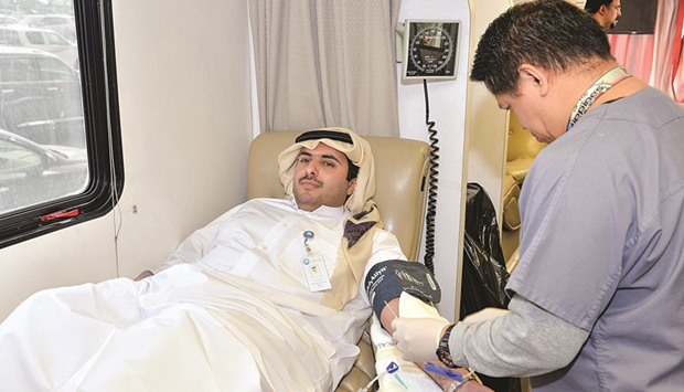 A QIB employee donating blood during the annual campaign.