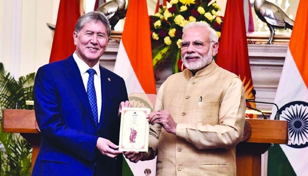 Prime Minister Narendra Modi presents Kyrgyz President Almazbek Atambayev with a Hindi translation of Kyrgyz epic Manas in New Delhi yesterday.