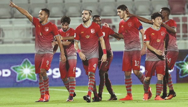 Lekhwiyau2019s Yousef El Arabi gestures to fans as teammates congratulate him after he scored against Al Sailiya in the Qatar Stars League yesterday.
