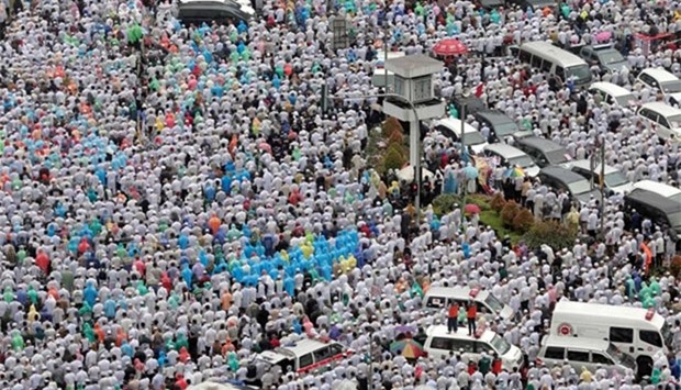 Indonesian Muslims pray at a rally calling for the arrest of Jakarta\'s Governor Basuki Tjahaja Purnama, popularly known as Ahok, in Jakarta on Friday.