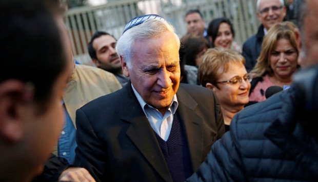 Former Israeli President Moshe Katsav (C) leaves the Maasiyahu prison, as he was released on parole after serving five years of his seven-year sentence, in Ramle, Israel.