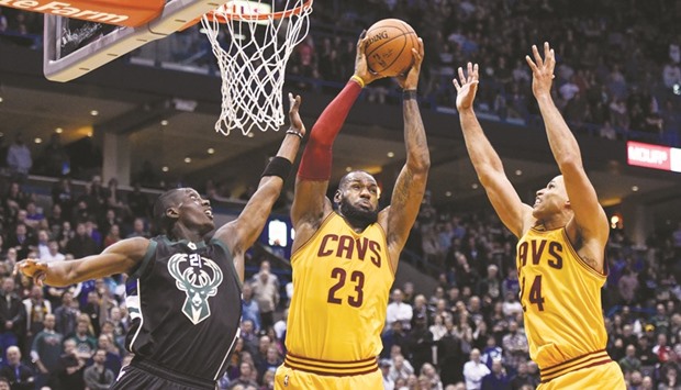 Cleveland Cavaliers forward LeBron James (C) grabs a rebound with help from forward Richard Jefferson (R) against Milwaukee Bucks guard Tony Snell in overtime at BMO Harris Bradley Center. James scored 34 points to help the Cavaliers beat the Bucks 114-108. PICTURE: USA TODAY Sports