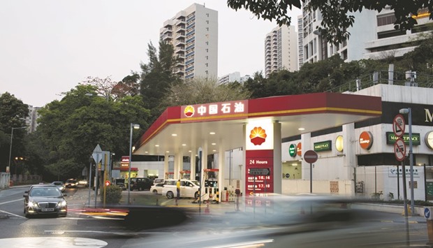 Vehicles move past a Petrochina gas station in Hong Kong. PetroChina and other oil majors have expanded storage capacity in recent months in anticipation of strong demand for the heating fuel.