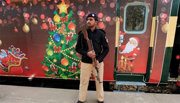 A policeman stands guard near the Christmas Peace train during a ceremony ahead of Christmas celebrations in Islamabad on Thursday.
