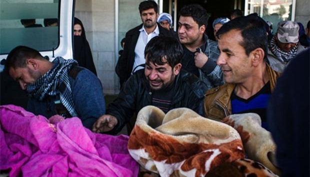 A man from a district of Mosul, where a suicide attack killed at least 23 civilians, mourns the death of his relative outside a hospital in Erbil, on Thursday.