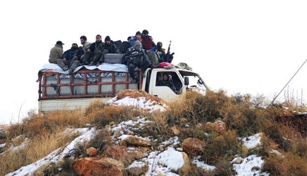 Syrian rebel fighters are evacuated from Aleppo on Thursday.