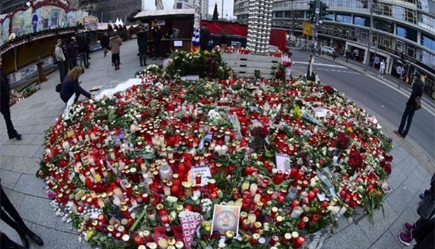 Candles, flowers and messages are placed at a makeshift memorial for the victims of the Christmas market attack in Berlin on Thursday.