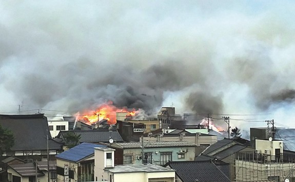 Flames and smoke rise during a blaze that engulfed multiple houses and buildings at Itoigawa city, Niigata prefecture yesterday. A rapidly-spreading fire engulfed more than 100 buildings and sparked evacuations in the northern Japanese city leaving two injured and forcing authorities to mobilise troops.