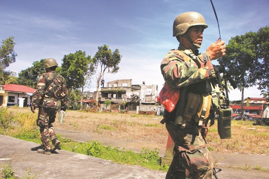 Military troops retake and occupy the old Butig town hall in Butig, Lanao del Sur in Mindanao island yesterday.