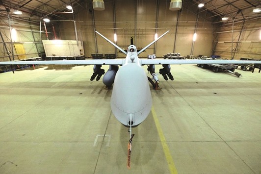 A US Air Force MQ-9 Reaper drone sits armed with Hellfire missiles and a 500-pound bomb in a hanger at Kandahar Airfield, Afghanistan March 9, 2016.