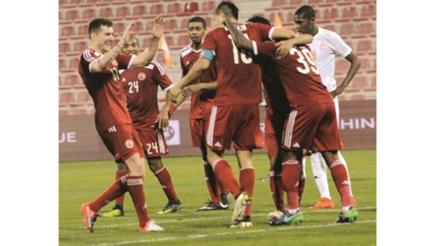 Al Arabi players celebrate one of their goals against Umm Salal.