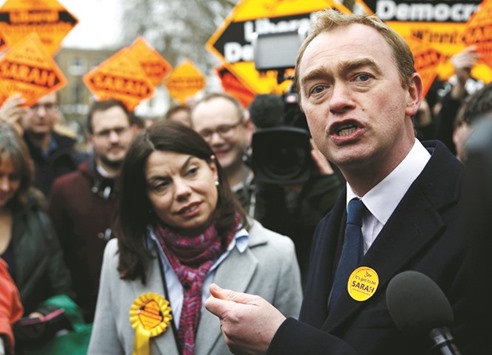 Liberal Democrat winner of the Richmond Park by-election, Sarah Olney, celebrates her victory with party leader Tim Farron on Richmond Green in London yesterday.