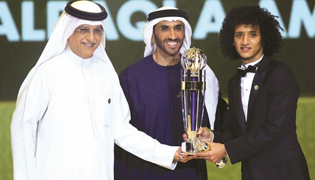 Asian Football Confederation (AFC) president Sheikh Salman bin Ebrahim al-Khalifah (left) and Abu Dhabi Sports Council chairman Sheikh Nahyan bin Zayed al-Nahyan (centre) present Omar Abdulrahman (right) with a trophy after being named the AFC Menu2019s Footballer of the Year during the Asian Football Confederationu2019s Annual Awards ceremony in Abu Dhabi on Thursday.
