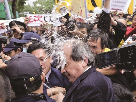 This photograph from Taiwan agency CNA Photo, taken yesterday, shows senior Democratic Progressive Party official Ker Chien-ming being splashed with water as he left the legislative complex in Taipei.