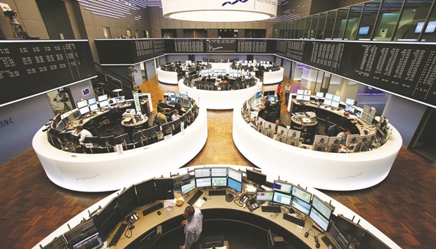 Traders work at the Frankfurt Stock Exchange. The DAX 30 closed down 0.2% to 11,433 points yesterday.