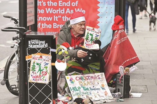 A homeless man sells The Big Issue magazine outside a tube station in north London, yesterday. A research study has found that street sleepers were almost 17 times more likely than the average person to have been a victim of violence, and 15 times more likely to have suffered verbal abuse.