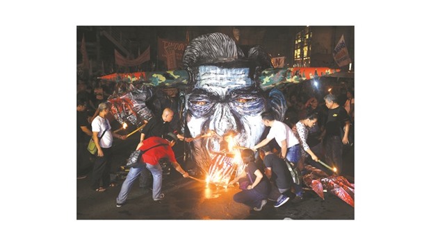 A recent photo shows activists and martial law victims burning an effigy of late dictator Ferdinand Marcos during a protest in observance of Human Rights Day in Manila.