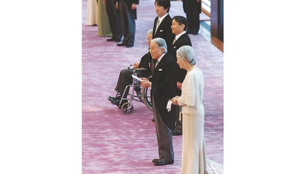Japanu2019s Emperor Akihito, accompanied by Empress Michiko, speaks to guests during a tea reception to celebrate his birthday at the Imperial Palace in Tokyo yesterday.
