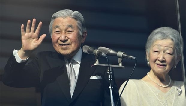 Japanese Emperor Akihito waves to well-wishers as Empress Michiko looks on during a public appearance on the balcony of the Imperial Palace in Tokyo on Friday.