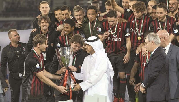 HE the Prime Minister and Interior Minister Sheikh Abdullah bin Nasser bin Khalifa al-Thani handing over the trophy to AC Milan captain Riccardo Montolivo and stand-in skipper Ignazio Abate after the Italian Super Cup match yesterday. AC Milan defeated Juventus on penalties (4-3) at the Al Sadd stadium. The match was attended by a number of Sheikhs, ministers and guests of the country as well as a large audience of fans of the two clubs.