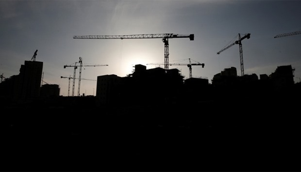 A construction site is silhouetted in the Israeli settlement of Har Homa