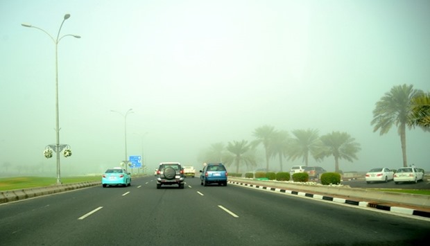 Sketchy movement of vehicles along the Corniche route when thick fog hit Doha. PICTURES: Ram Chand