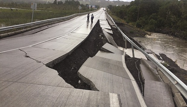 A road in Tarahuin, on Chiloe island, lies damaged after the quake, yesterday.