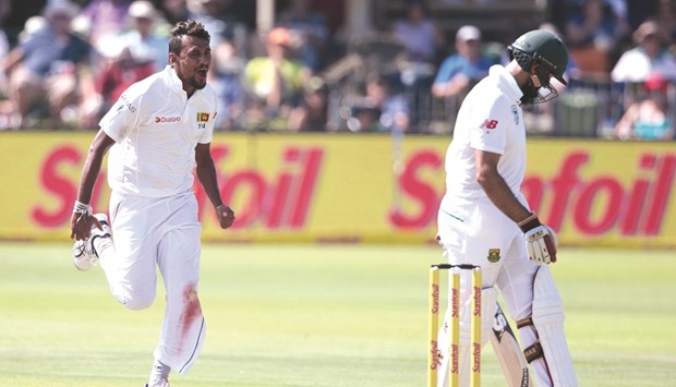 Sri Lanka bowler Suranga Lakmal (L) celebrates the dismissal of South African batsman Hashim Amla (R) during the first day of the first Test in South Africa.