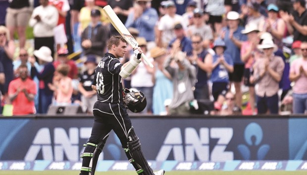 New Zealandu2019s Tom Latham lifts his bat to the crowd as he walks from the field after being caught out during the ODI against Bangladesh in Christchurch.