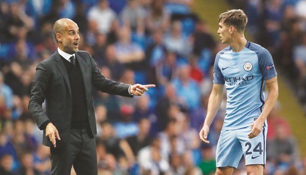Man City coach Pep Guardiola speaks to John Stones. (Reuters)