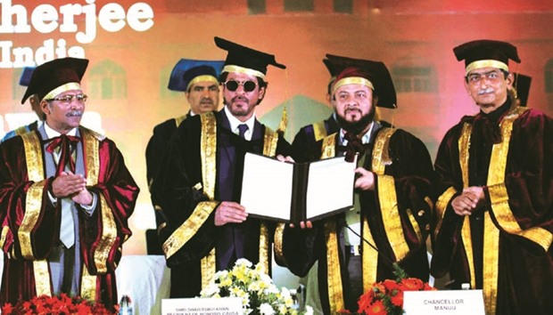 Shah Rukh Khan (centre left) receives an honorary doctorate from the Moulana Azad National Urdu University Chancellor Zafar Sareshwala in Hyderabad yesterday.