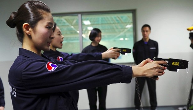 Crew members of Korean Air using stun guns at a training center in Seoul