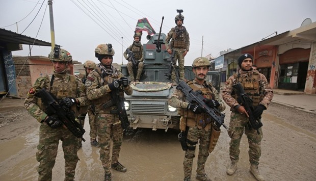 Iraqi pro-government forces patrol the eastern part of the embattled Iraqi city of Mosul