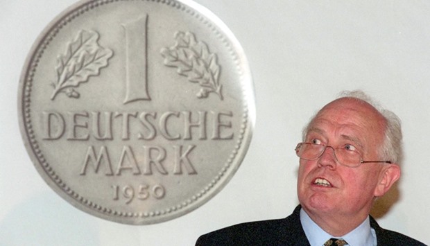 Picture taken on June 15, 1998 in Kassel, western Germany, shows then president of the German central bank Bundesbank Hans Tietmeyer next to a giant poster of the Deutsche Mark currency .