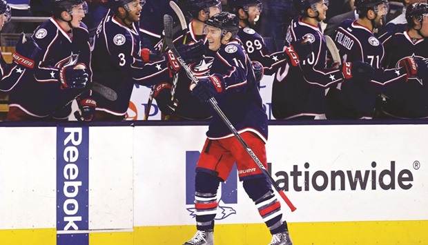 Columbus Blue Jackets left wing Matt Calvert (foreground) celebrates with teammates on the bench after scoring a goal against the Boston Bruins in the first period of their NHL game in Columbus, Ohio, on Tuesday. (USA TODAY Sports)