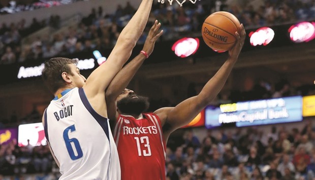 James Harden (right) of the Houston Rockets drives to the basket against Andrew Bogut #6 of the Dallas Mavericks in the first half of their NBA game in Dallas, Texas, on Tuesday. (AFP)