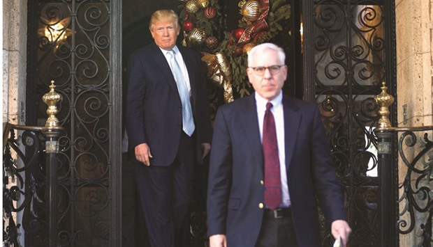 US president-elect Donald Trump watches as Carlyle Group founder and CEO David Rubenstein departs following their meeting at the Mar-a-lago Club in Palm Beach, Florida, yesterday.