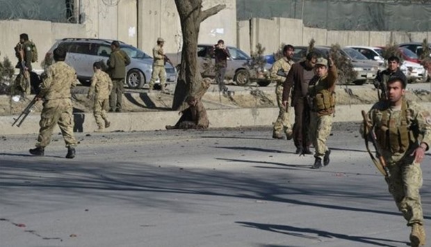 Afghan security personnel gather at the site of the bomb attack