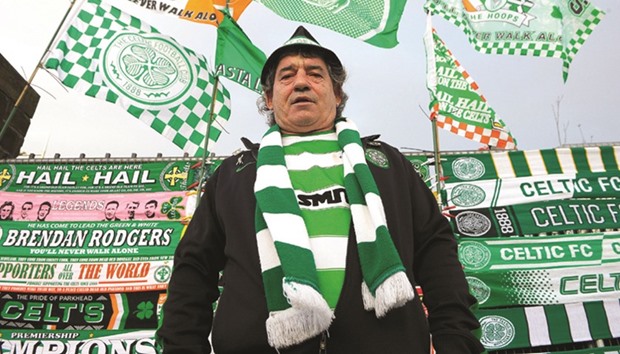 A Celtic fan stands in front of a stall at Celtic Park in Glasgow. File photo