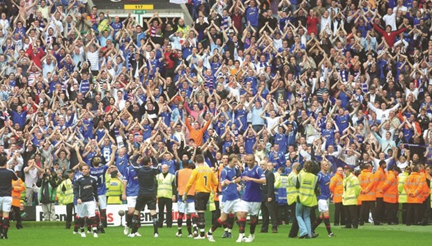 This file photo taken on August 31, 2008 shows Rangers fans celebrating their 4-2 victory over Celtic in their Scottish Premier League football match at Celtic Park, Glasgow, The u201cOld Firmu201d derby between the Celtic and Glasgow Rangers, whose 404th edition is scheduled for December 31, 2016 in Glasgow, is one of the most intense in Europe.
