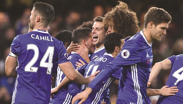 Chelseau2019s Belgian midfielder Eden Hazard (CL) celebrates with teammates after scoring their second goal from the penalty spot during their English Premier League game against Bournemouth at Stamford Bridge in London on December 26.
