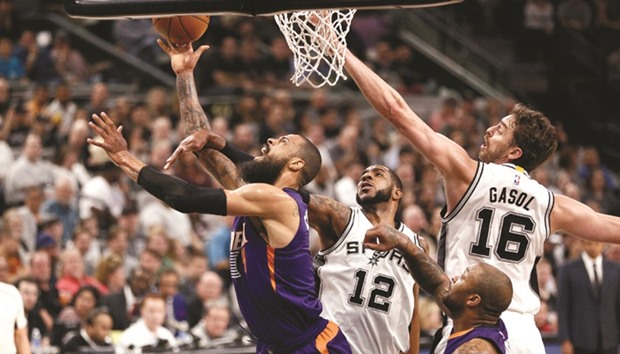 Phoenix Suns centre Tyson Chandler shoots the ball past San Antonio Spurs power forward LaMarcus Aldridge (No 12) and Pau Gasol during the first half at AT&T Center. PICTURE: USA TODAY Sports
